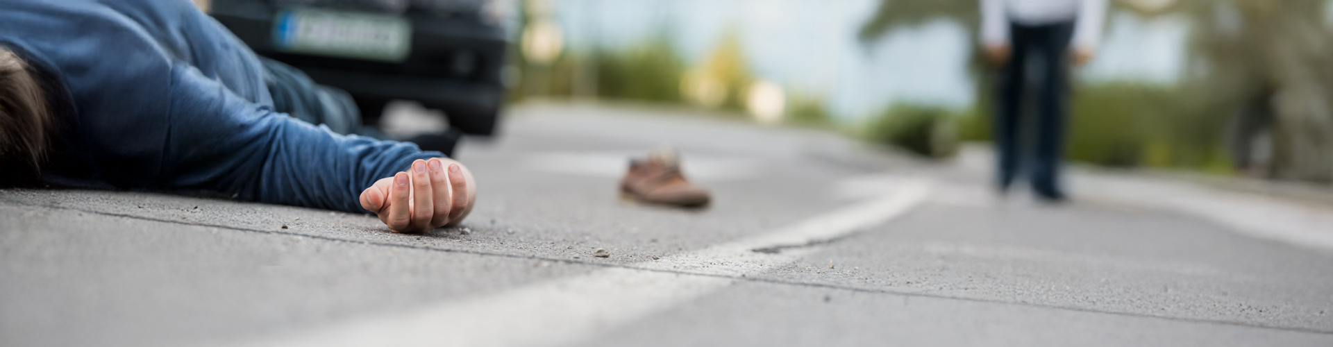 pedestrian on ground after being hit by car